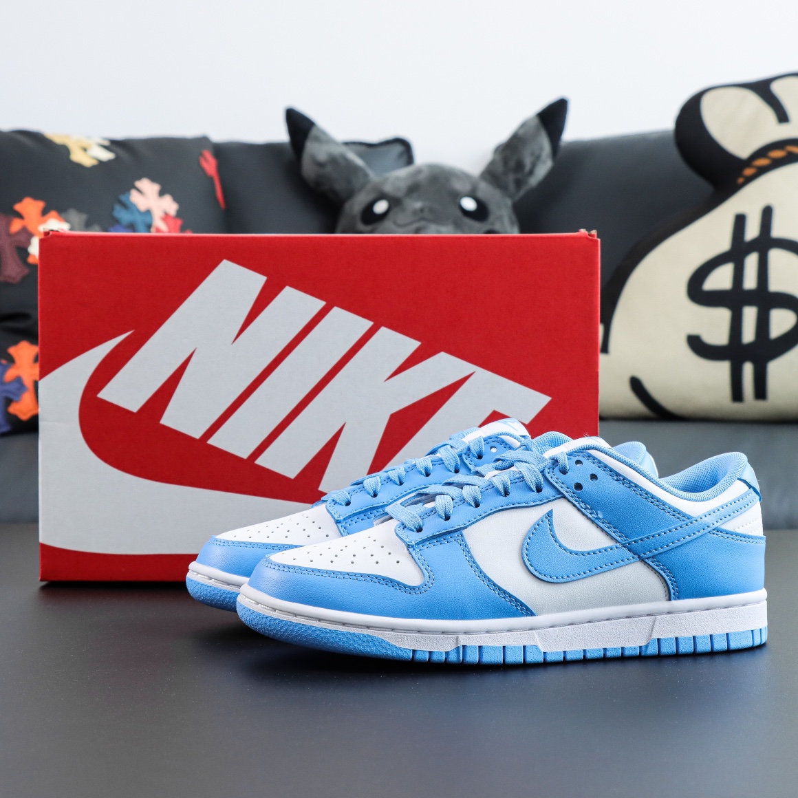 UNC Dunks Reps with powder blue and white colorway placed in front of box