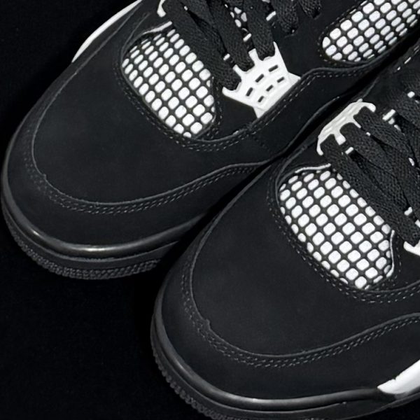 Close-up of toe box on Jordan 4 White Thunder Reps