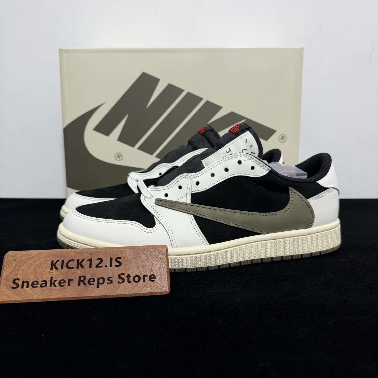 Travis Scott Jordan 1 Olive Reps with box displayed on table