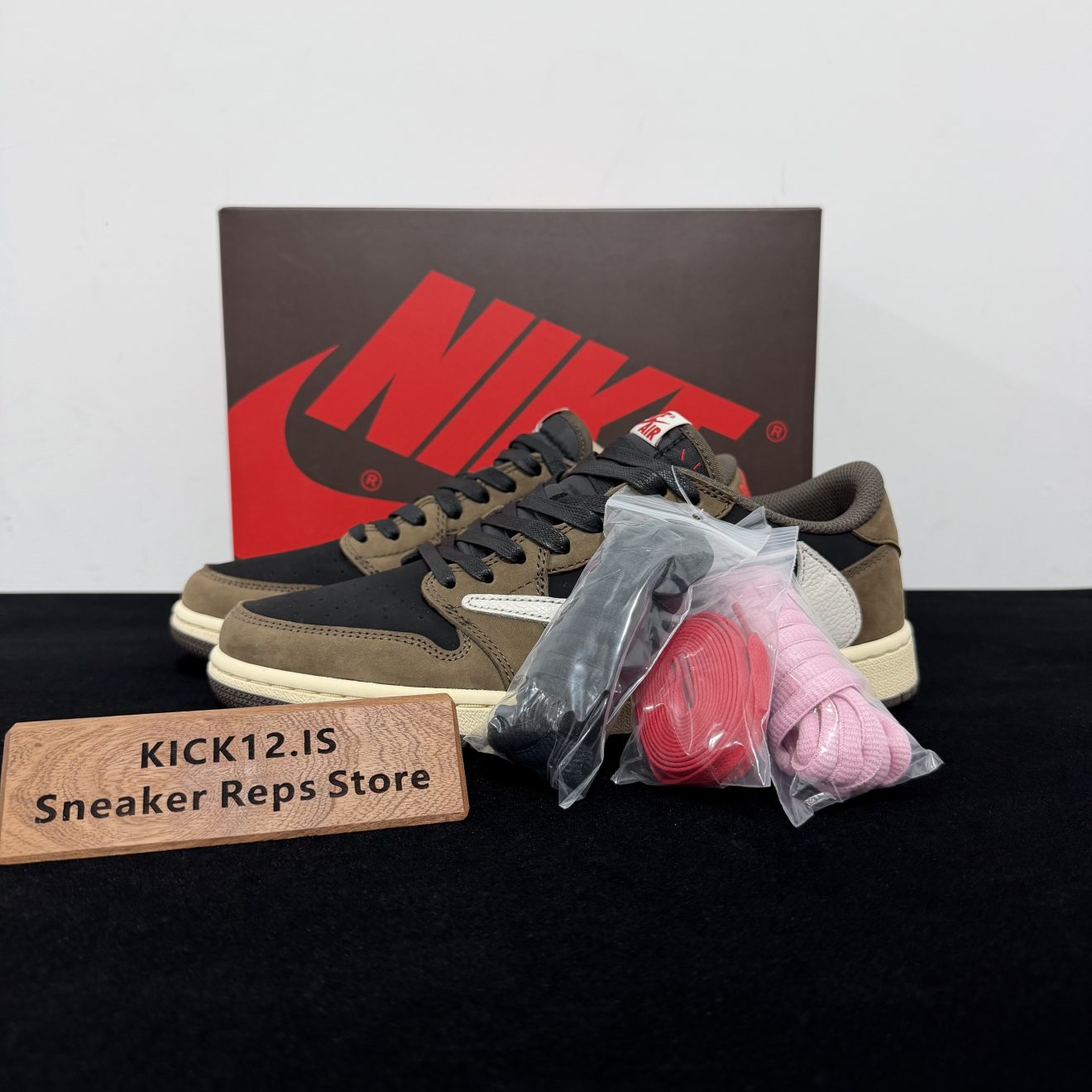 Travis Scott Jordan 1 Low Mocha Reps with box displayed on table