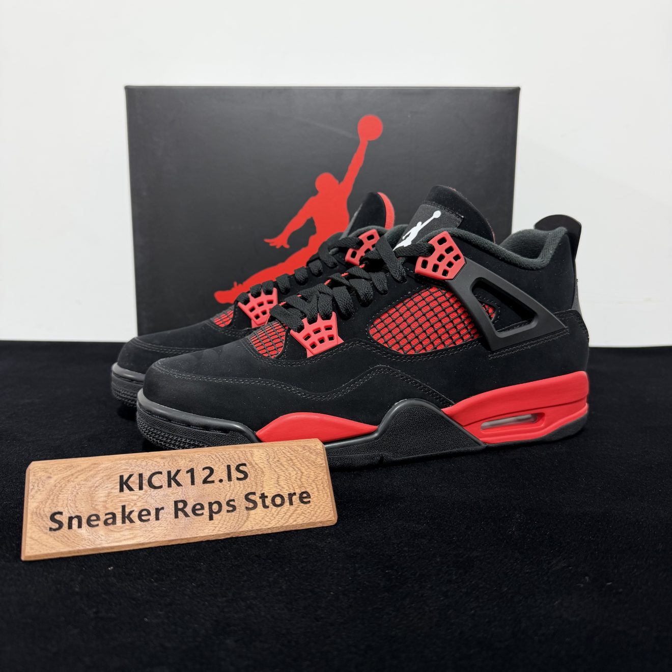 Jordan 4 Red Thunder Reps with box displayed on table