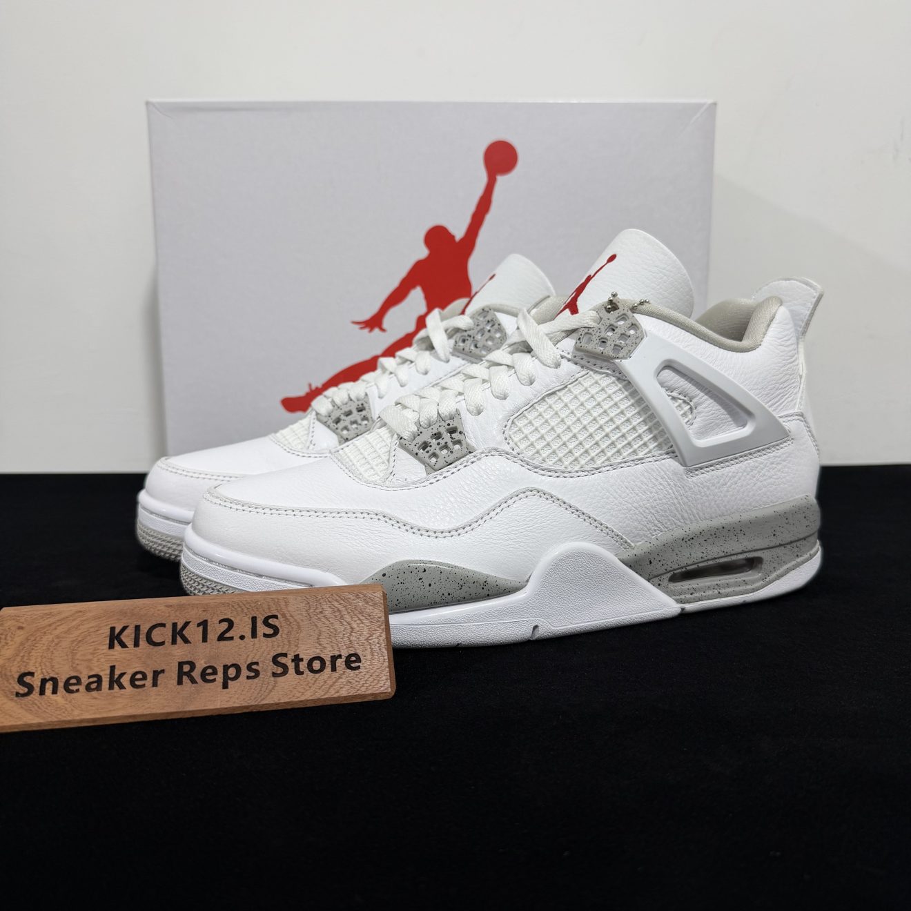 Jordan 4 White Oreo Reps with box displayed on table