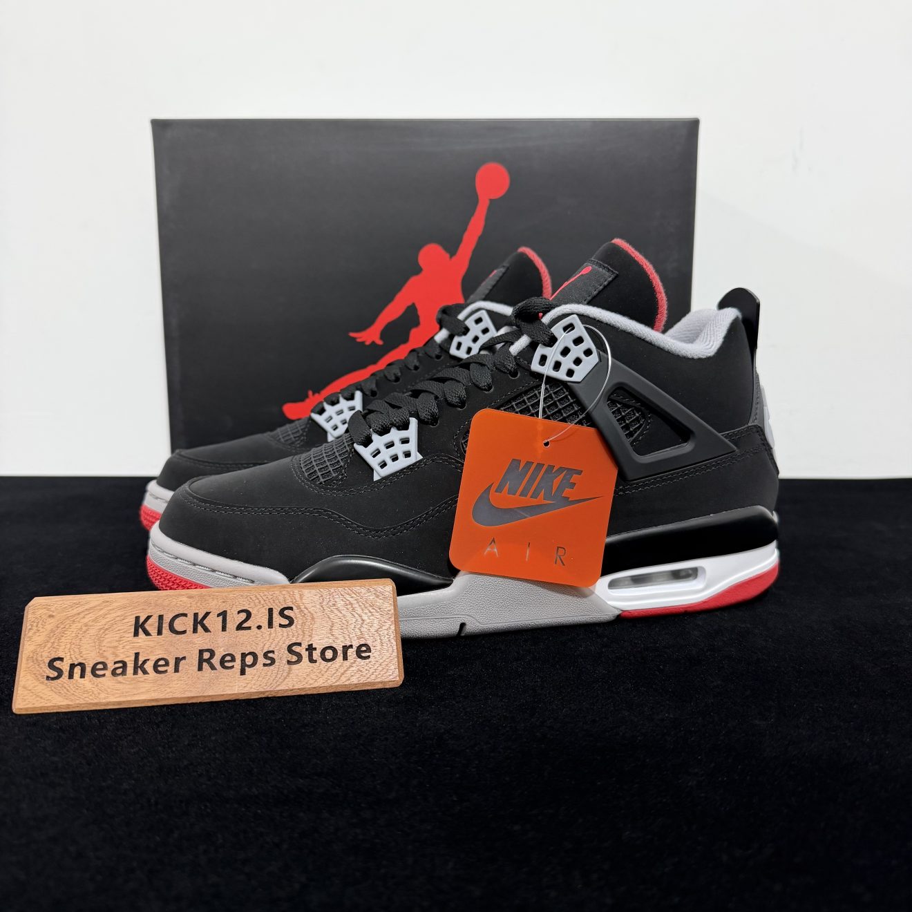 Jordan 4 Bred Reps with box displayed on table