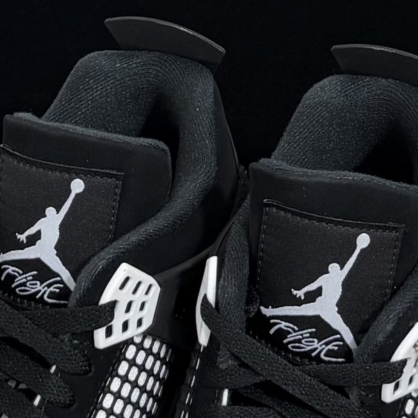 Close-up of tongue on Jordan 4 White Thunder Reps with Jumpman logo