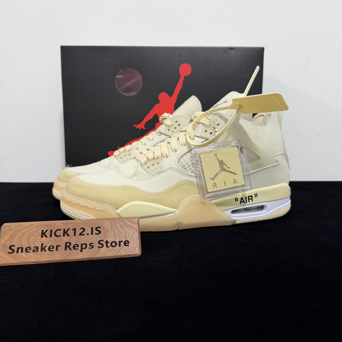 Jordan 4 Off White Reps with box displayed on table