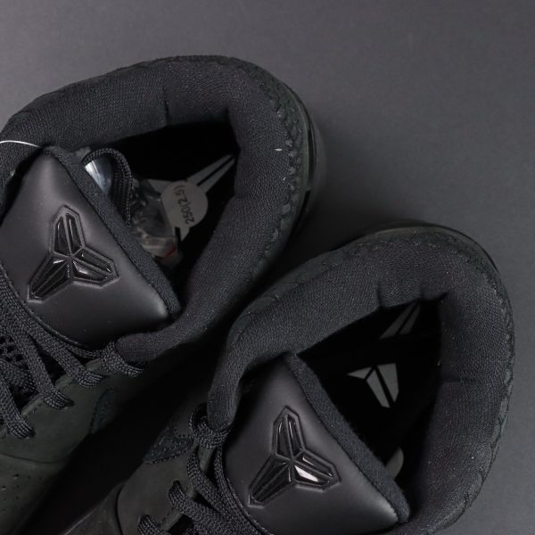 Kobe logo on tongue of Kobe 4 Black Mamba reps in black and gold