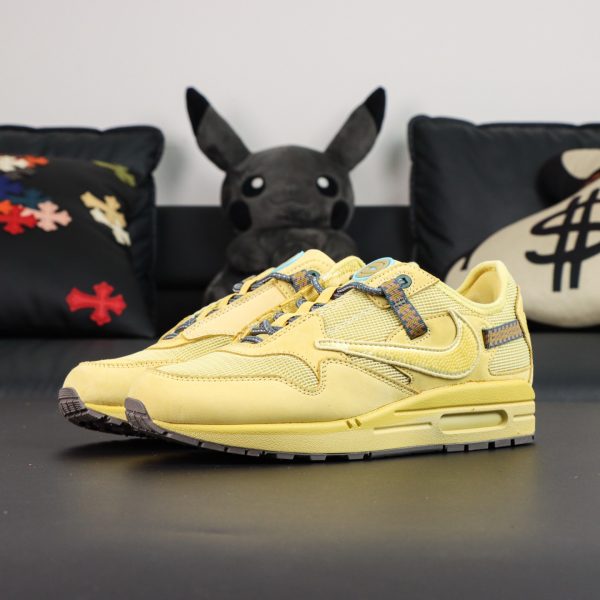 Side view of Air Max 1 Saturn Gold Reps with canvas overlays and reverse Swoosh