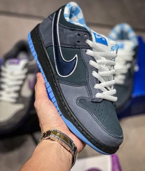 Blue Lobster Dunk Reps handheld side view showing dark navy suede upper