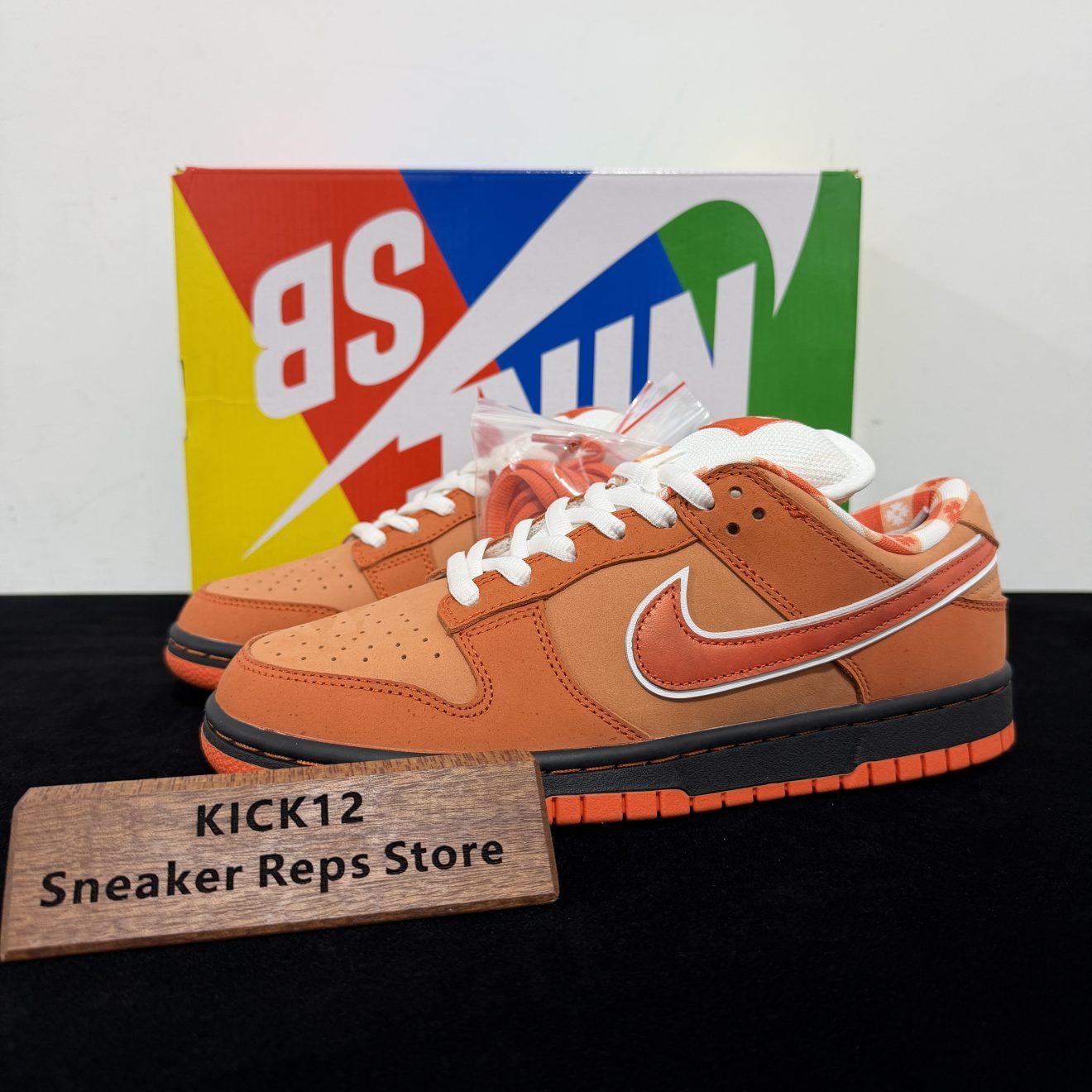Orange Lobster Dunks Reps with box displayed on table
