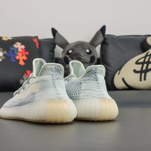 Side heel view of Cloud White Yeezy 350 with pull tab and knit curvature
