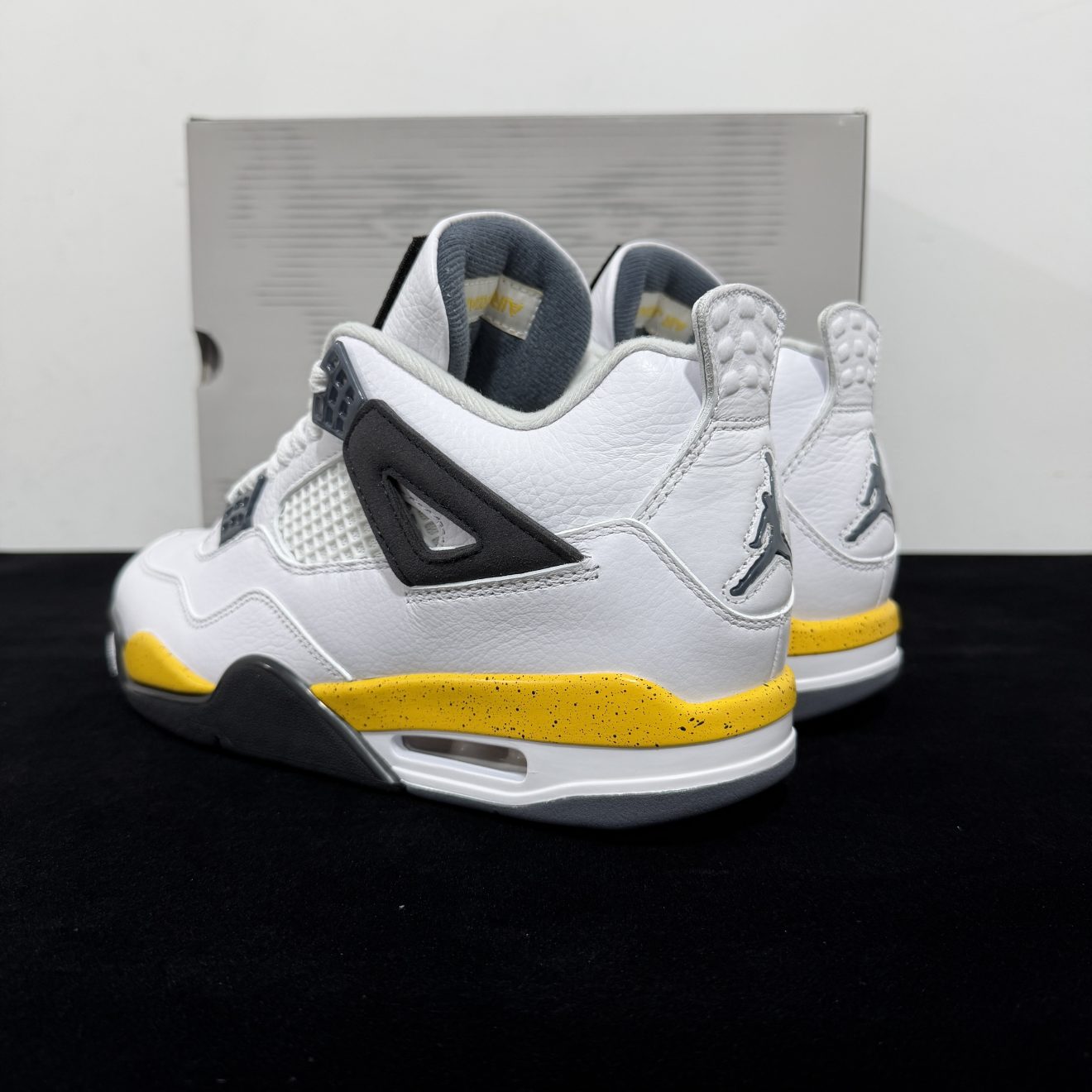 Heel side of Jordan 4 Rare Air Tour Yellow Reps with black heel tab