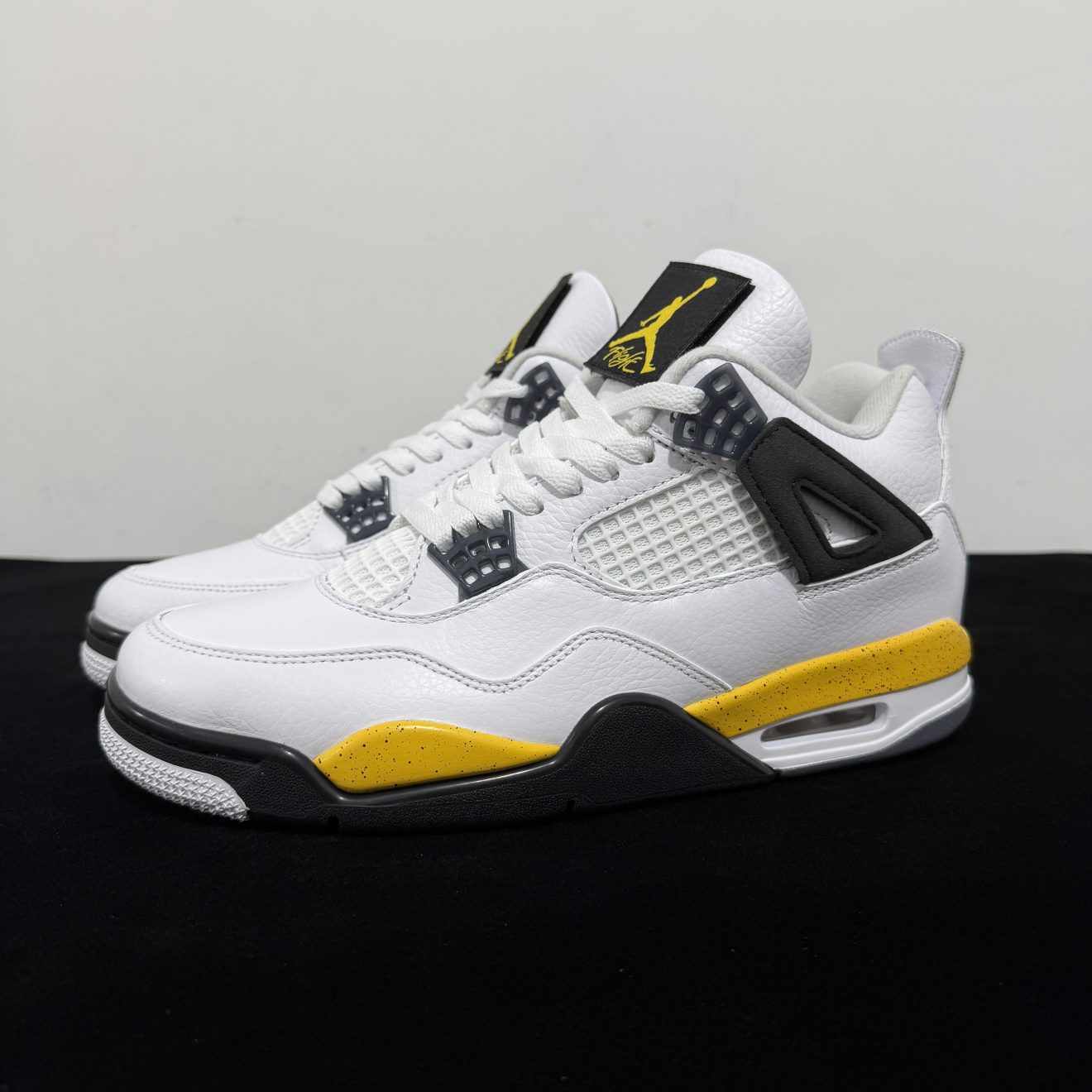 Side view of Jordan 4 Rare Air Tour Yellow Reps showing white leather and yellow midsole